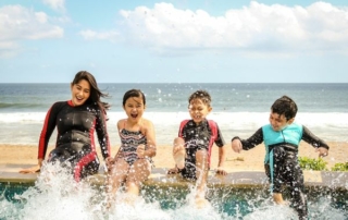 Family enjoying their vacation while splashing in the pool