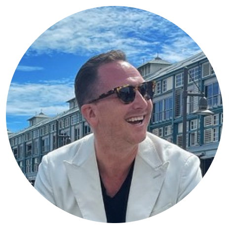Stephen-Howard 1 Headshot of Stephen Howard from Ovolo Hotels wearing sunglasses and a white jacket.