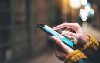 A person holds their phone in one hand.