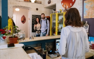 2 guests approach the front desk to check in, a process made easier with a data platform
