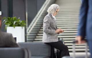 A business person waits to check in at a hotel.