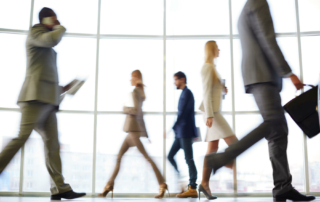 Business people walk past each other.