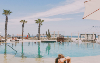 A person relaxes by the pool.