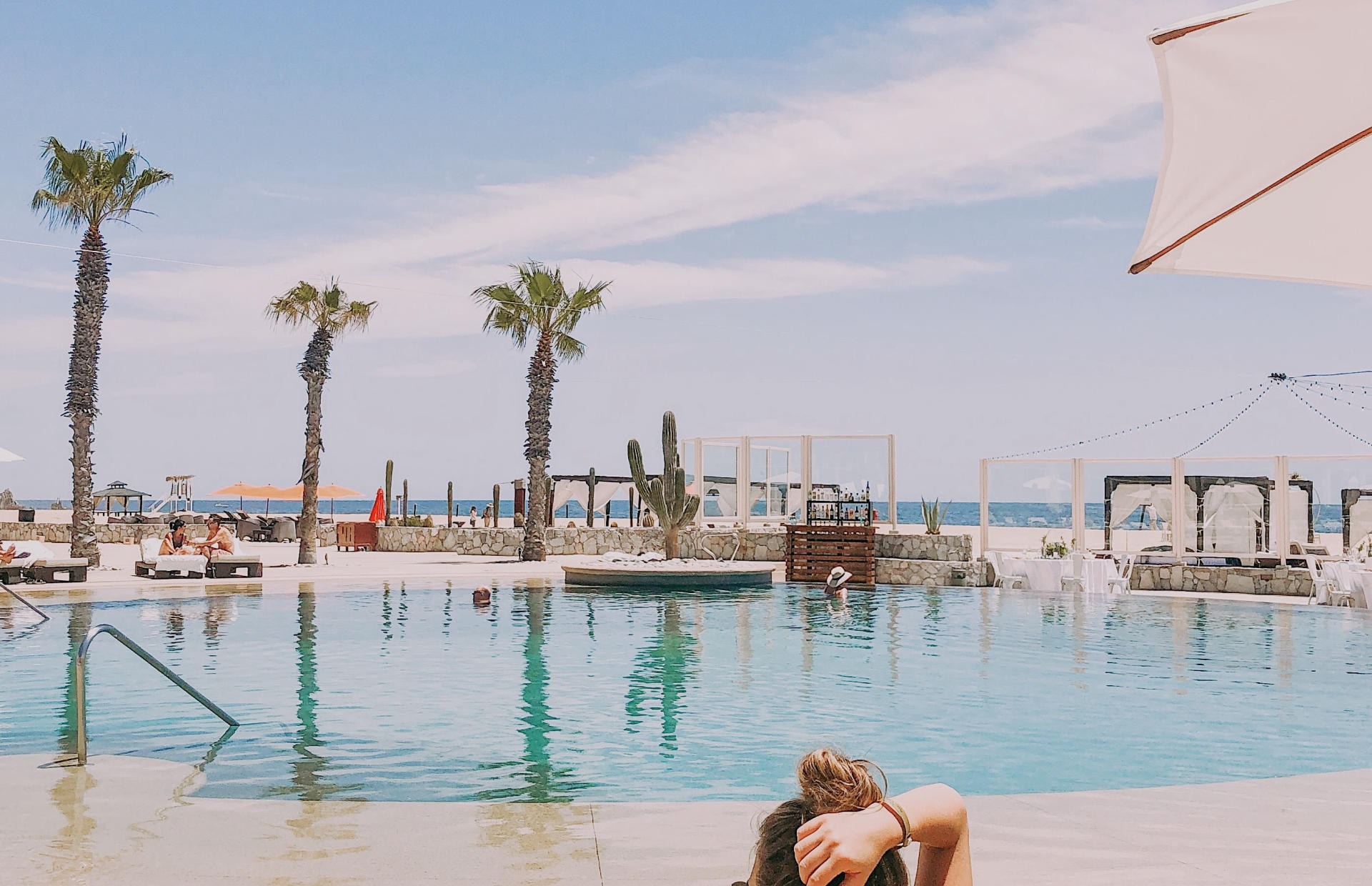 A person relaxes by the pool.