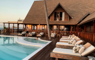 Hotel guests linger at a resort pool.