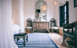 A hotel room is decorated with ornate tables and chairs.