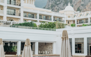 The second-story view of a hotel overlooks the pool.