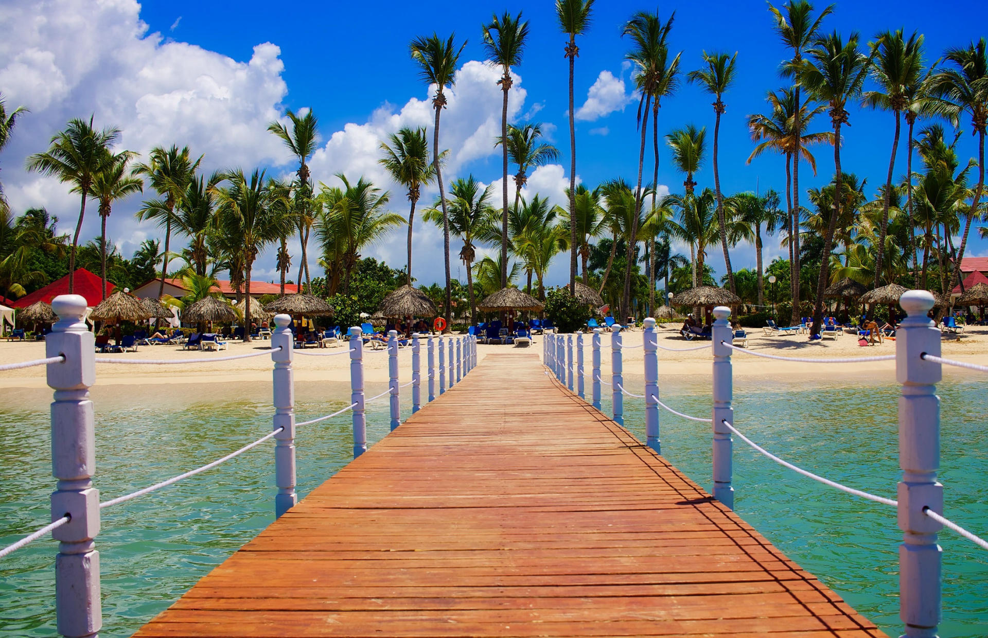 A boardwalk stretches from the shore into the ocean.