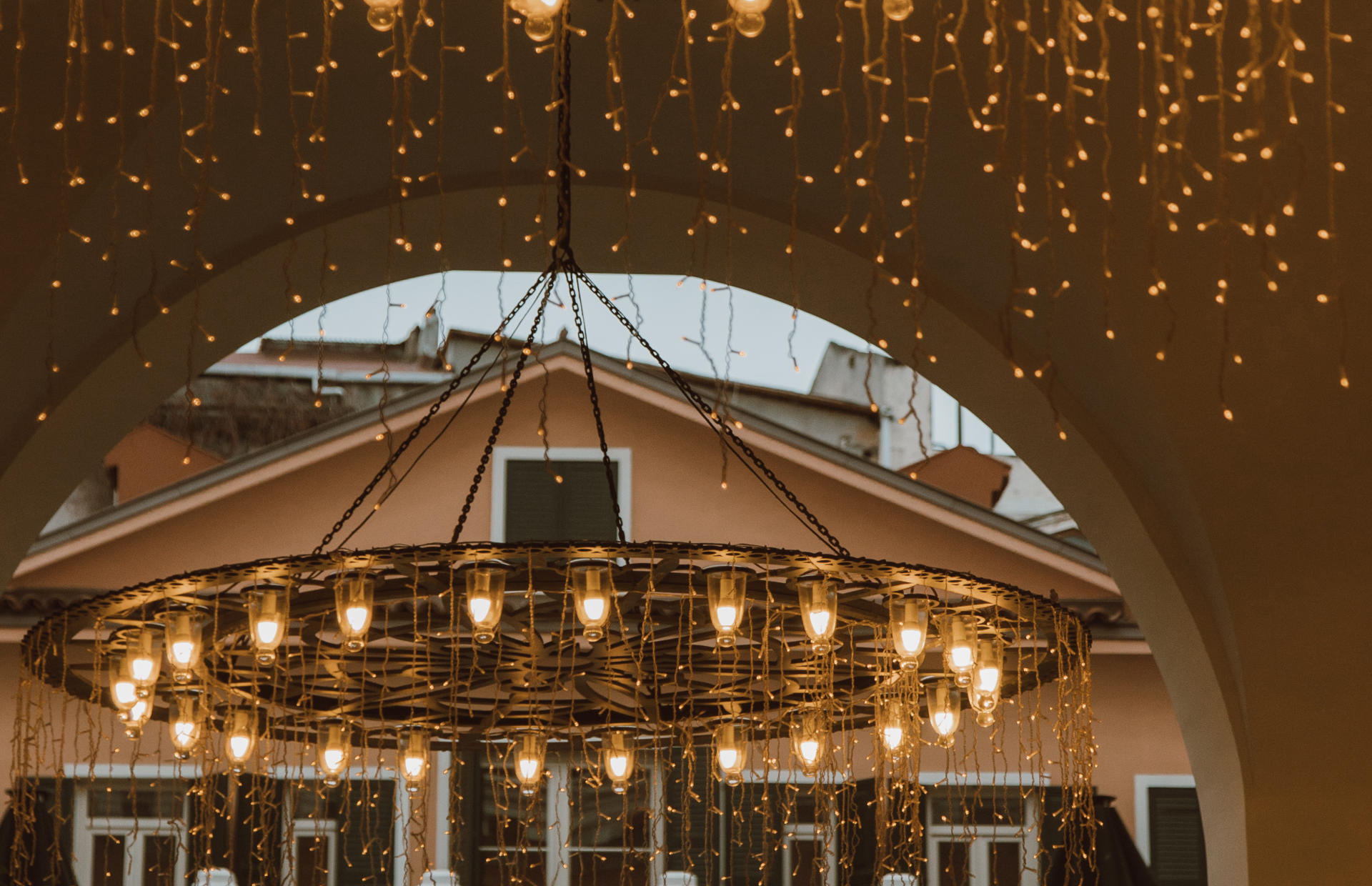 A hotel chandelier hangs with twinkly lights.