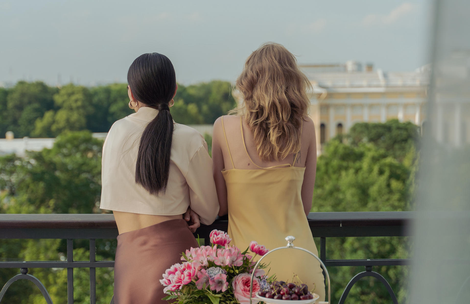 Two guests stand at a hotel balcony.