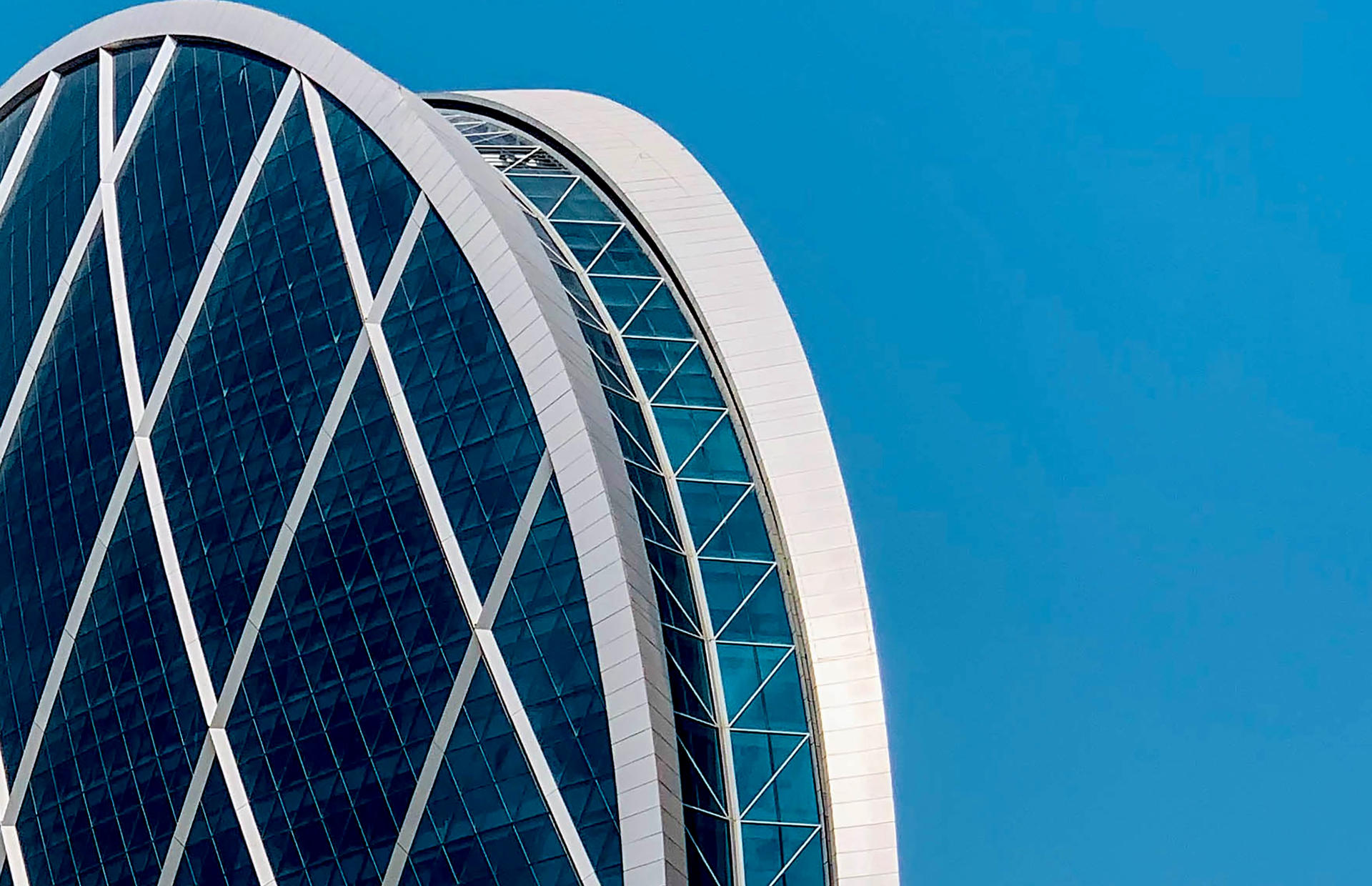 A hotel with a round roof and glass windows.