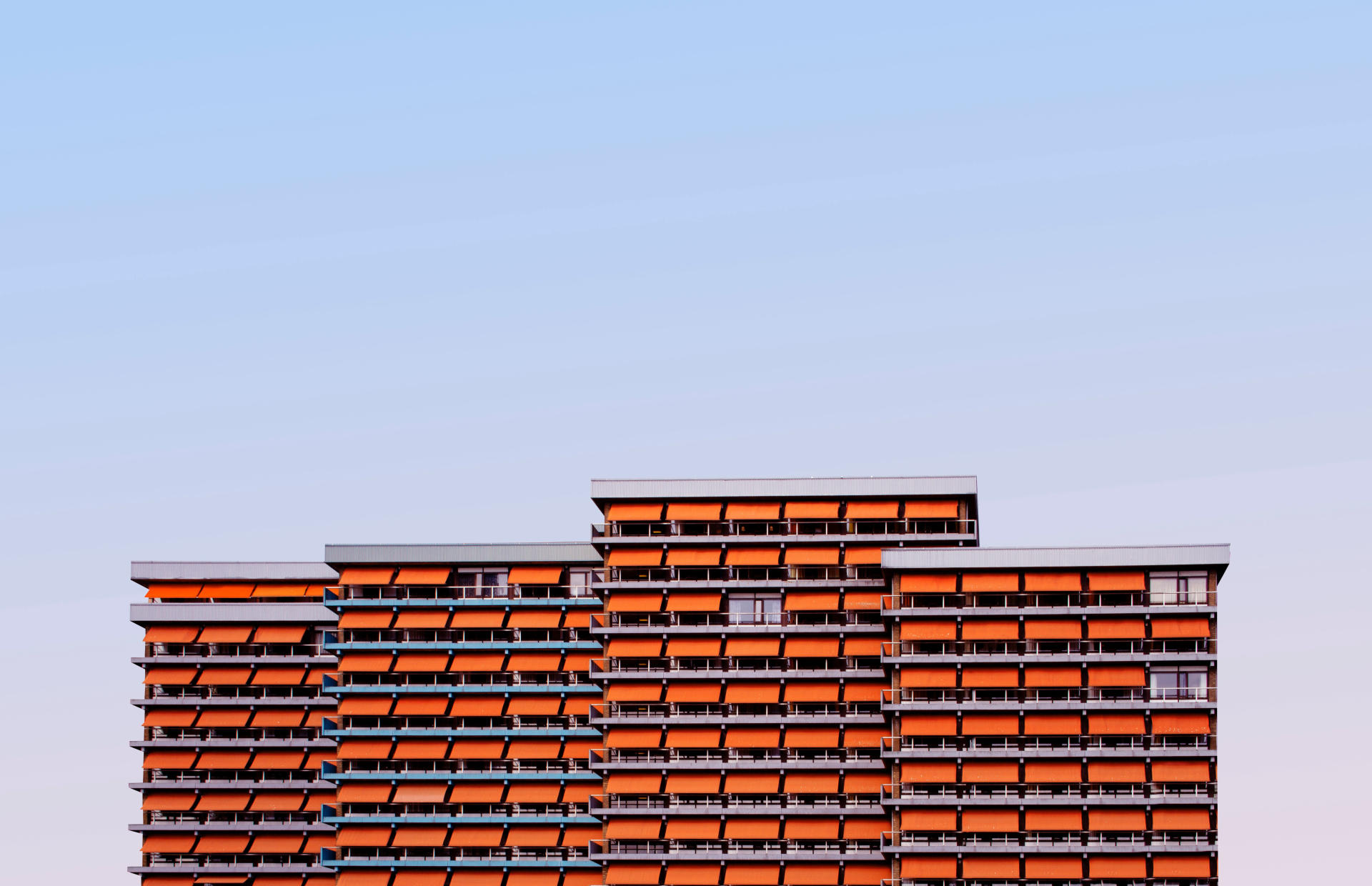 There is a hotel with orange awnings.