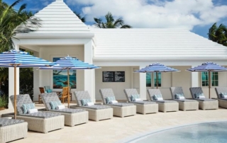 Lounge chairs and umbrellas by the pool at an EOS Hospitality property