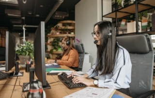 2 hotel call center agents working with guests over the phone