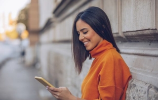 Woman looking at her phone smiling