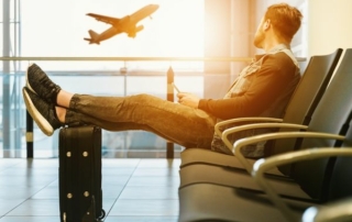 Traveler reading a hotel newsletter while waiting at an airport gate