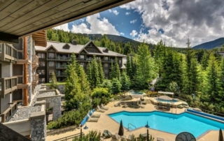 A pool surrounded by trees at a Clique Hotels & Resorts property