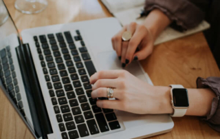 Woman using laptop to book hotel reservations.