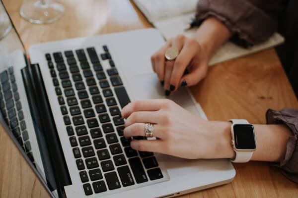 Woman using laptop to book hotel reservations.