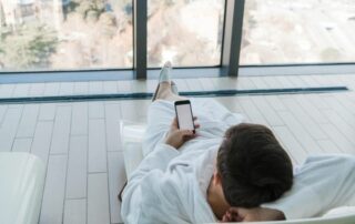 Man in a hotel robe using a text messaging solution