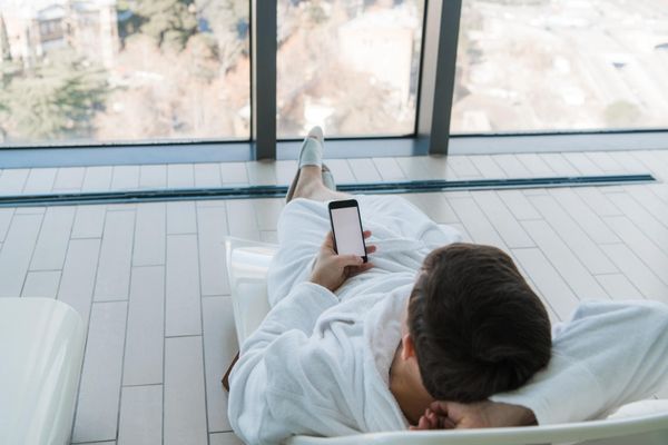 Man in a hotel robe using a text messaging solution