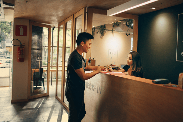 A guest checks in at the front desk.