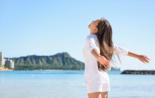 Woman happy by the beach