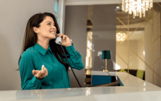 Hotel receptionist on the phone.