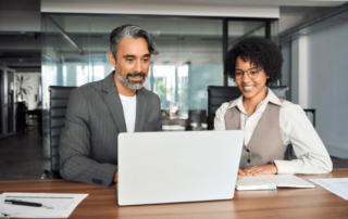 Business professionals around computer