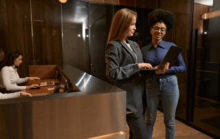 Women with a laptop at hotel front desk