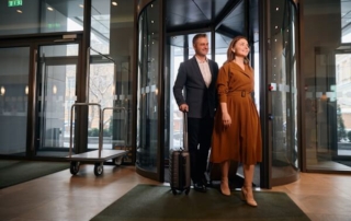 Adult Caucasian couple entering hotel.