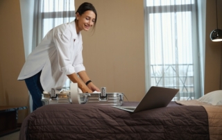 Young woman taking clothes from suitcase.