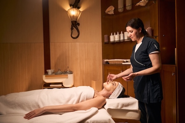 A woman enjoys spa treatment at a hotel.