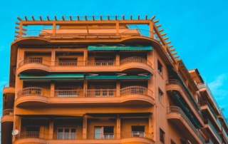 Orange hotel exterior against a blue sky.