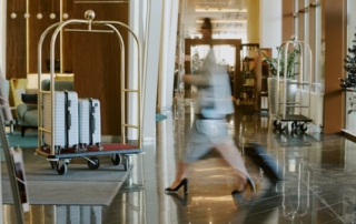 Unrecognizable woman in hotel lobby moving quickly.