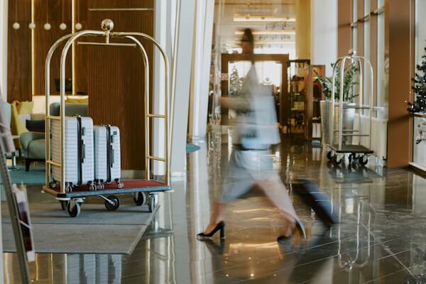 Unrecognizable woman in hotel lobby moving quickly.