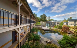 Hotel exterior overlooking a pond.