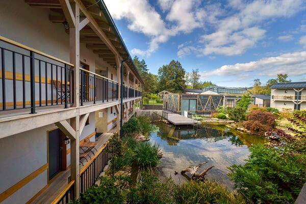 Hotel exterior overlooking a pond.